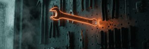 Glowing orange wrench on a tool wall in a workshop setting.