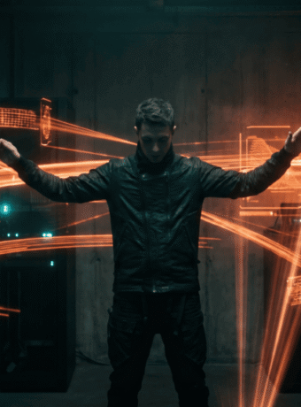 Futuristic man with glowing orange light trails in a dark room.