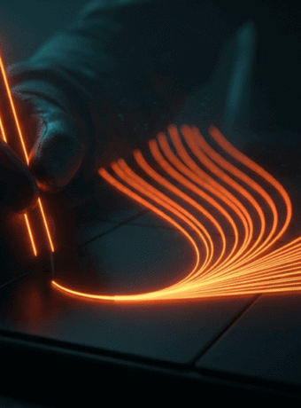 Futuristic digital pen creating glowing orange lines on a tablet.