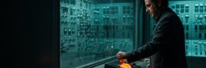 Man operating a control panel in a high-tech server room.