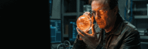 Man examining a glowing orange AI hologram in a high-tech lab.