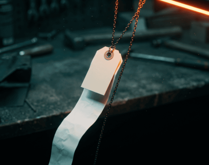 A blank price tag hanging on a chain above a workbench with a long paper receipt unspooling into shadow, illustrating the real cost of AI software for small business