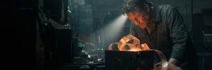 Skilled artisan working with glowing metal in a high-tech workshop.