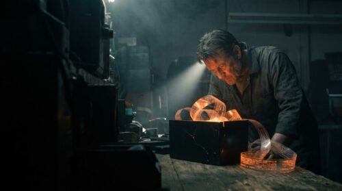 Skilled artisan working with glowing metal in a high-tech workshop.